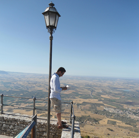 Adam stands high atop a castle overlooking Trapani airfiled in Sicily while conducting research for "A Higher Call."